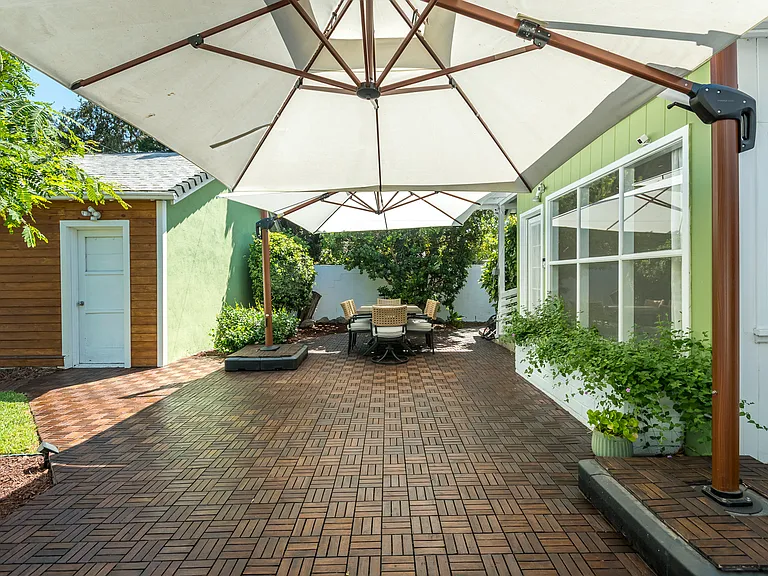 Private backyard retreat featuring a large patio for dining and entertaining, plus a lush lawn for play and relaxation.
