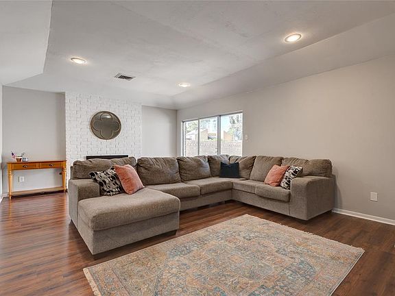 15x12 Family Room - Fireplace with brick surround, slightly raised ceiling and view to the patio enhance leisure time.