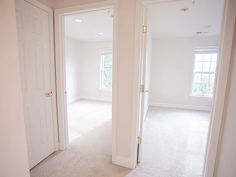 Walk out the hallway to face 2 additional bedrooms and a linen closet
