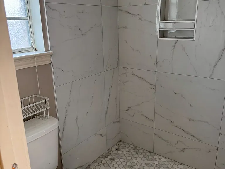 __ Primary Bathroom
"Beautifully remodeled bathroom featuring a walk-in tile shower, modern fixtures, and fresh finishes."