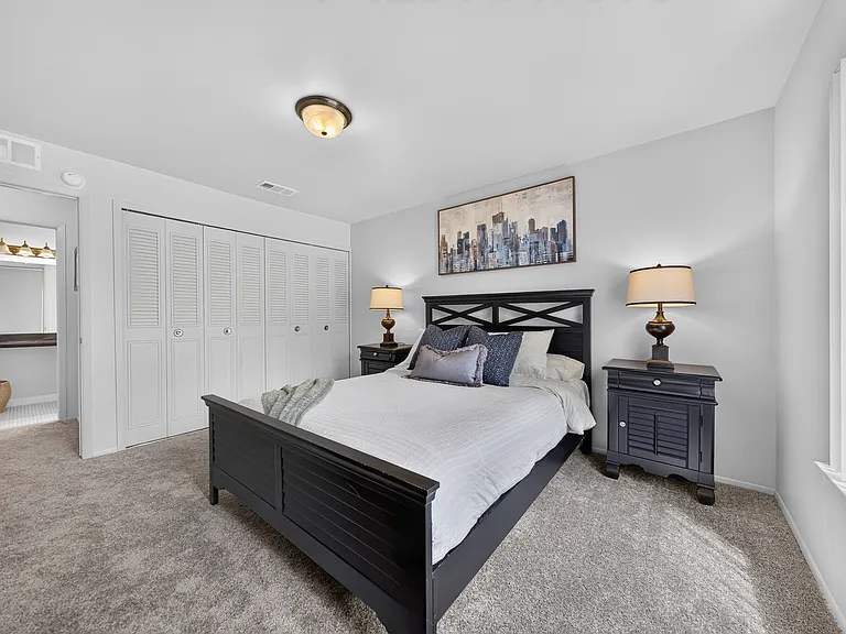Cozy bedroom with ample storage space at Drawbridge Apartments in Harrison Township, MI.
