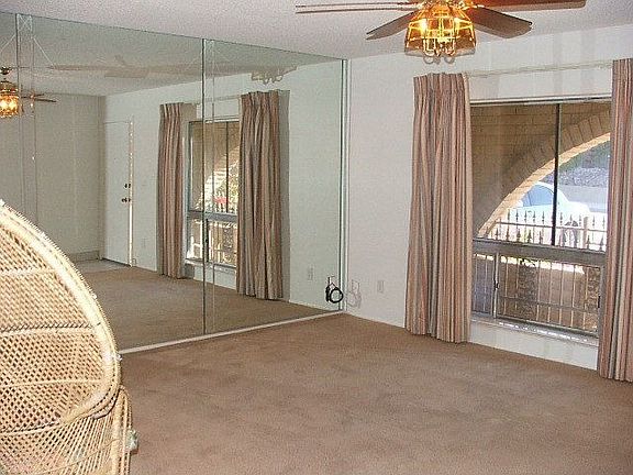 Large living room with plush carpet and picturesque window.
