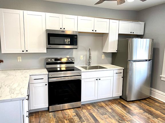 Kitchen with brand new stainless steel appliances.