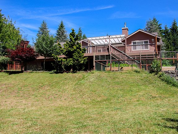 Huge grassy backyard backs up to woods.