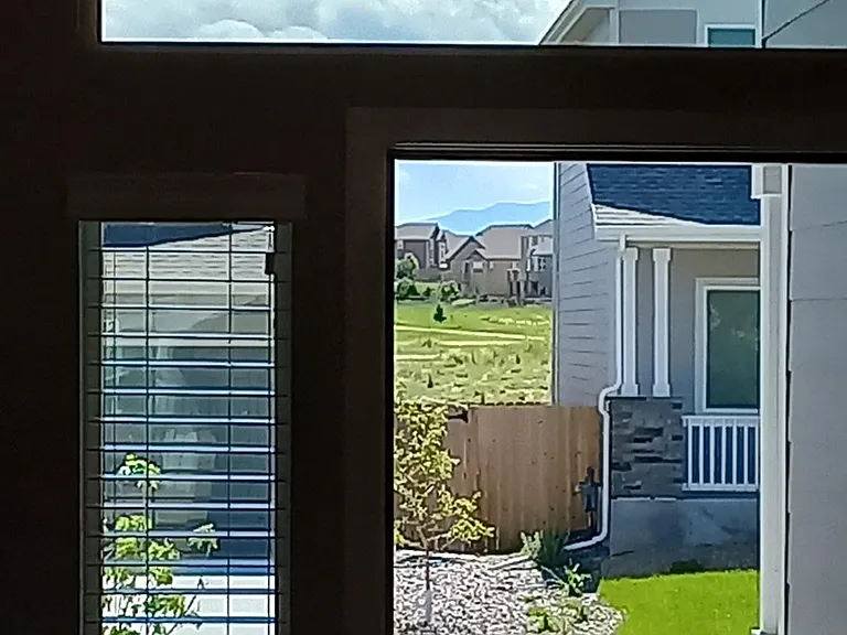 Looking out the front door, side-window shades open.
