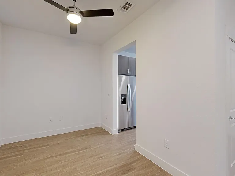Apartment dining room with wood-style flooring.