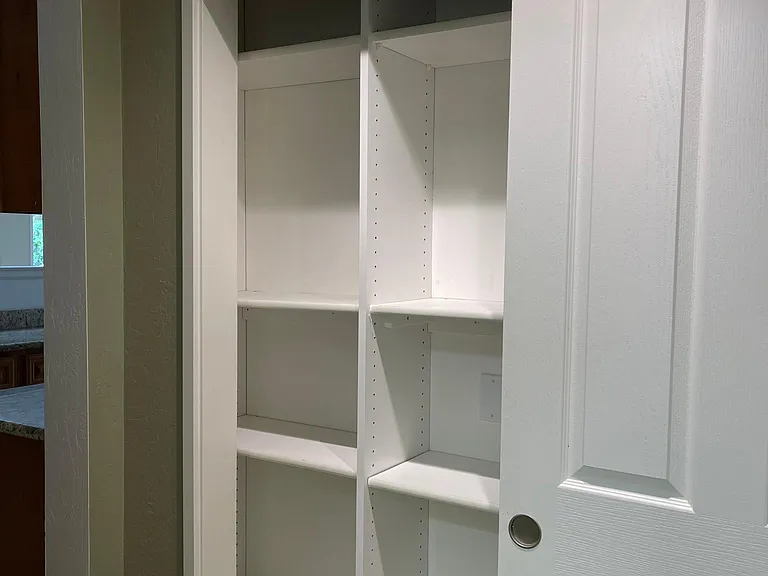 Pantry adjacent the kitchen and laundry room