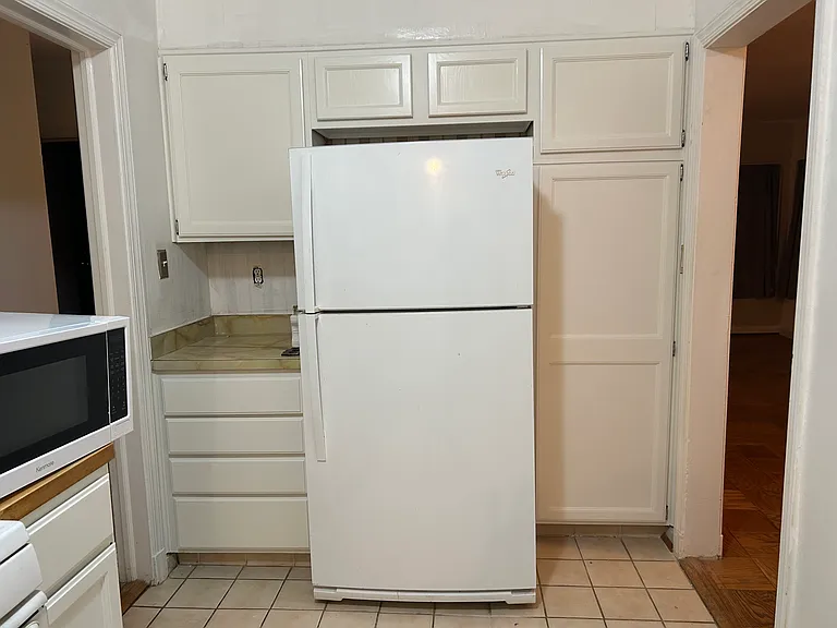 Pantry area beside the refrigerator as well as hall pantry