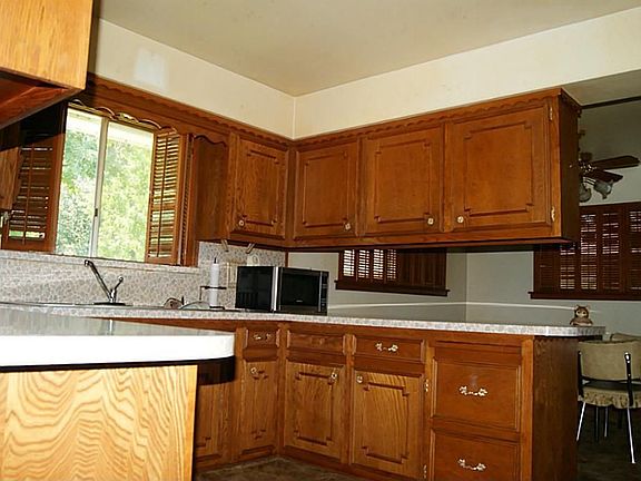 Nice cabinets, kitchen window overlooks back yard, large sink.