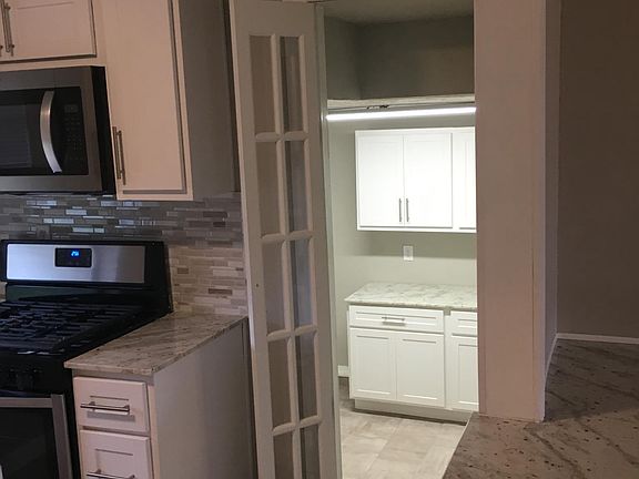 French doors lead to a very large utility room off kitchen c