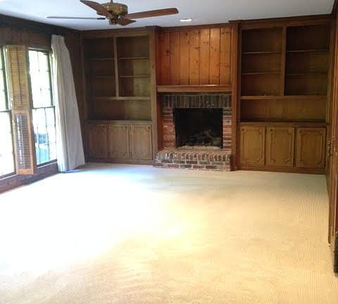 Main level den that open out onto brick patio. Wood burning