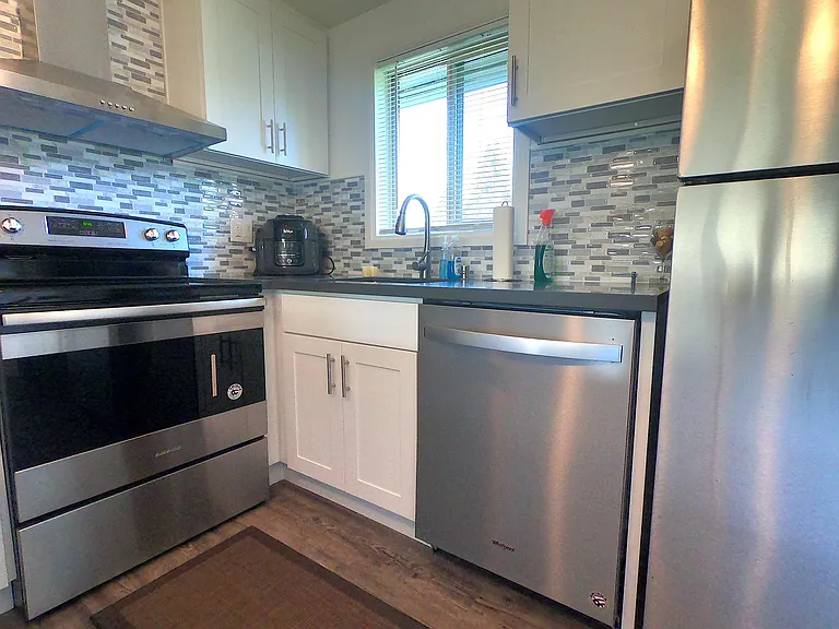 Newer dishwasher and range. Slow close cabinets. Garbage disposal, faucet with touch sensor, over the range hood vented to outside.