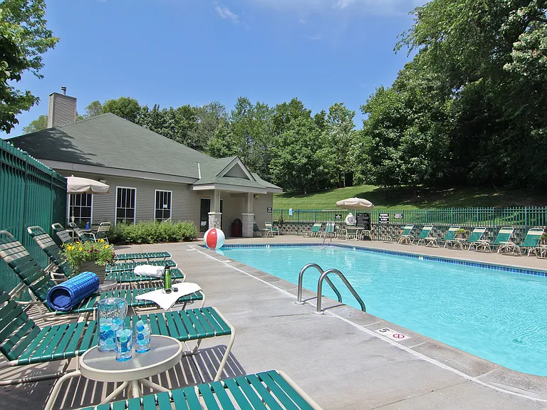 Heated outdoor pool with sundeck and plenty of seating