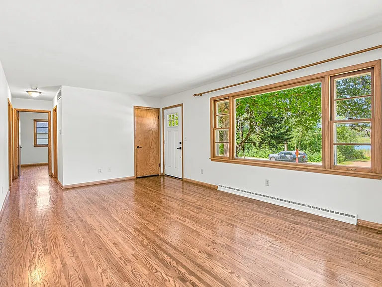 Large Living Room with abundant windows and tranquil sunset views over Lake St. Joe! (19 x 12)