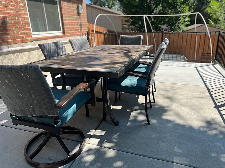 Outdoor patio dining table with seating for six, ideal for meals and gatherings.