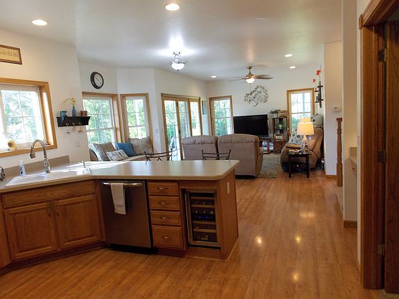 With the tall ceilings and open floor plan the kitchen flows well into the living room. With this view you can see the custom wine fridge that the seller installed. 