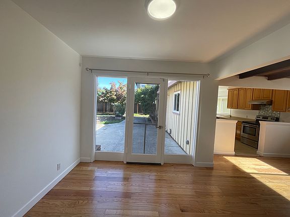 Dinning with freshly refinished hardwood floor, new interior paint, new, LED ceiling light, new mini split