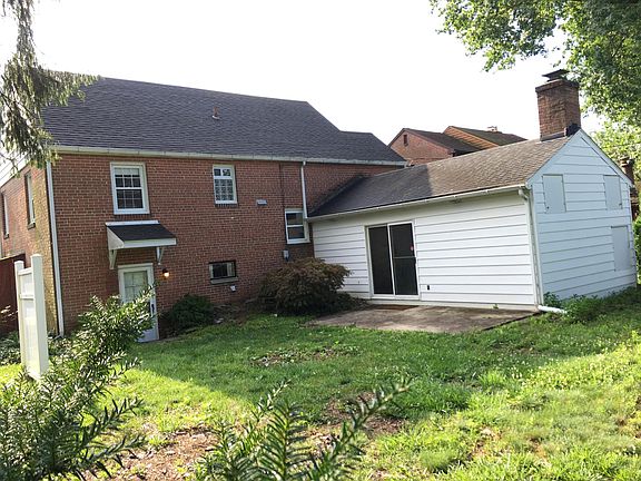 rear yard with patio area and entrance to family room and laundry room