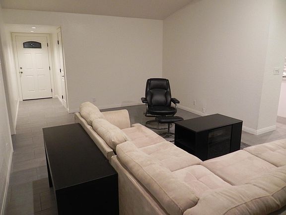 LIVING ROOM - Solid-core Entry door, floor tile, and ceiling canned LED lighting installed.