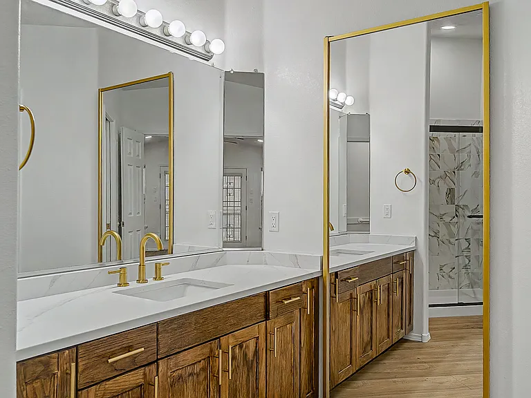 Primary bathroom sink with access to walk-in closet.