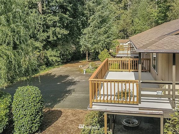 Drone view property from right, note large decks and plenty of parking. 