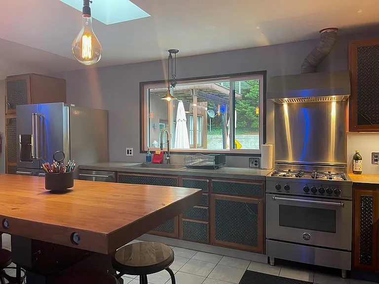 Shared kitchen equipped with luxury stainless steel appliances, fit for gourmet chef