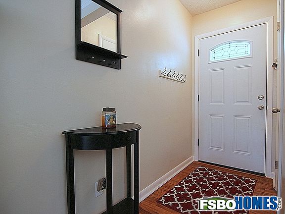 Front Entry with Hardwood Floors and Coat Closet to the Right