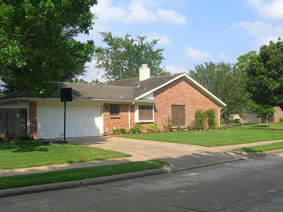 It is located at a corner lot with the garage access fron the other side.