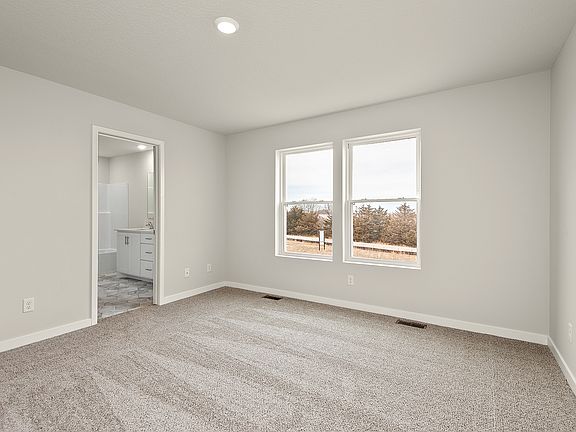 The master bedroom is spacious with a window,