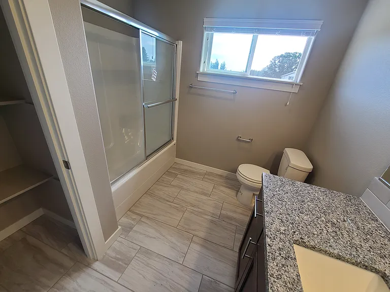 Upstairs hallway bathroom, full bath with tub shower and vanity with granite