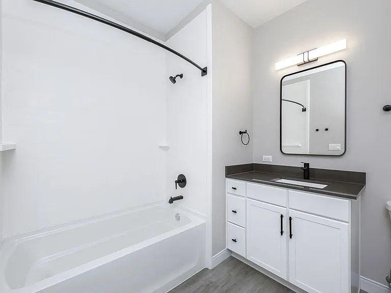 Spacious bathroom with quartz countertops and tub/shower combo
