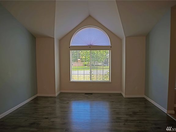 Living room with vaulted ceiling and updated flooring