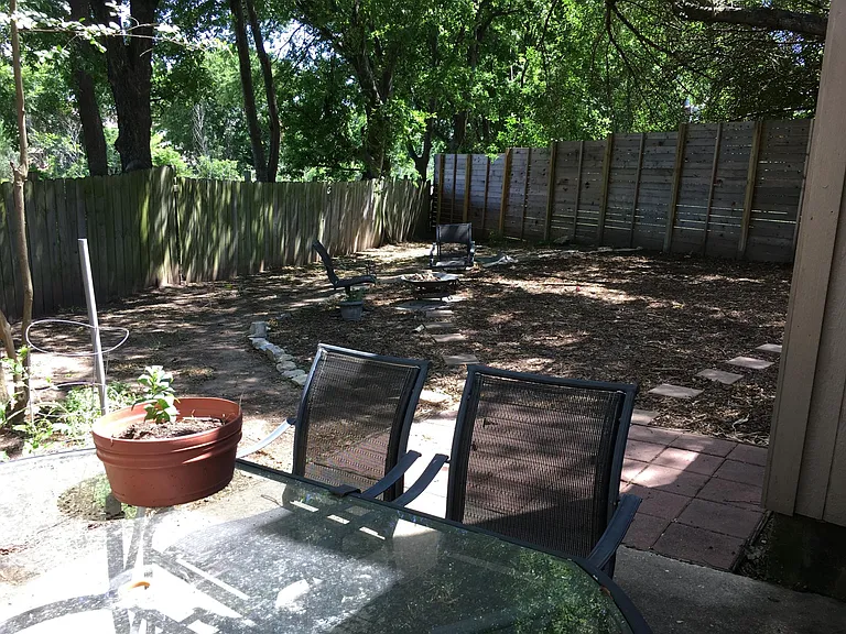 large backyard with paved patio off back door
