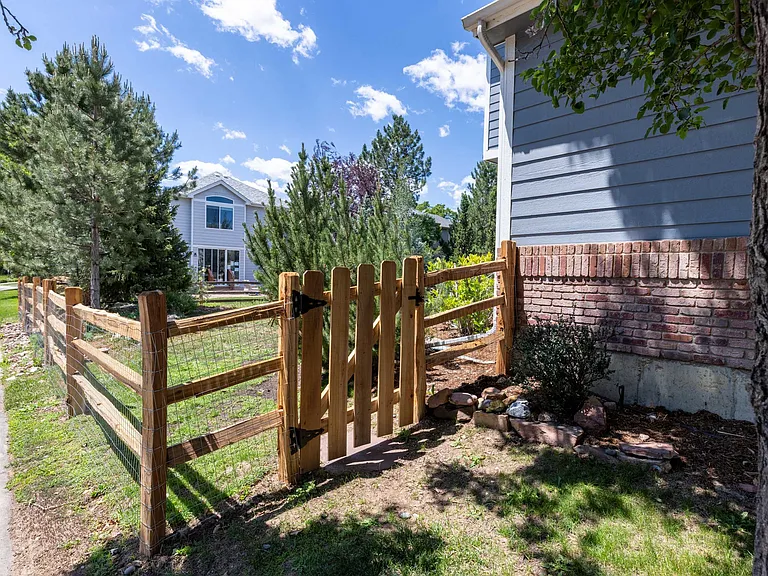 Recent exterior improvements include a new cedar gate and fencing, adding both charm and functionality to the outdoor space.