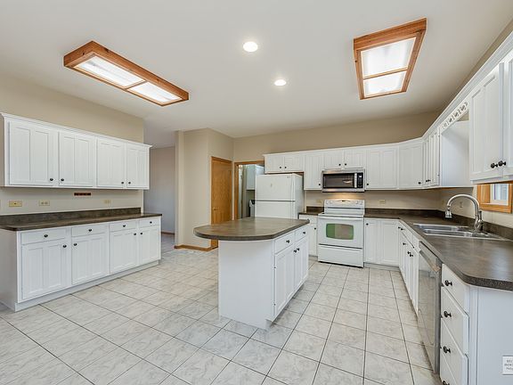 This spacious, eat-in kitchen has just been updated with professionally painted cabinetry.