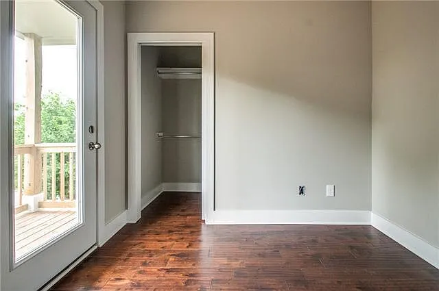 Third bedroom, custom blinds (not pictured) and walk in closet; private balcony above front porch facing 3rd Ave N