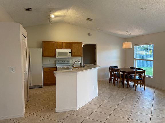 Large side by side refrigerator with built in water/ice dispenser. Self-cleaning range and built in microwave and dishwasher (not shown in picture).