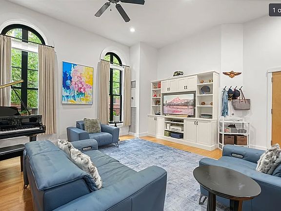 Living room with smart TV and reclining couches