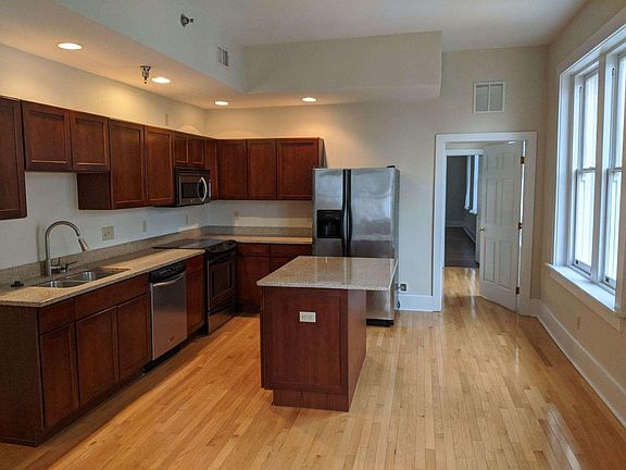 kitchen with granite and hardwood floors throughout.