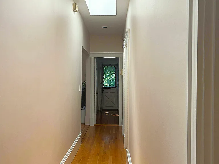 Hallway runs through entire apartment separating common areas from bedrooms. Two huge bright skylights.