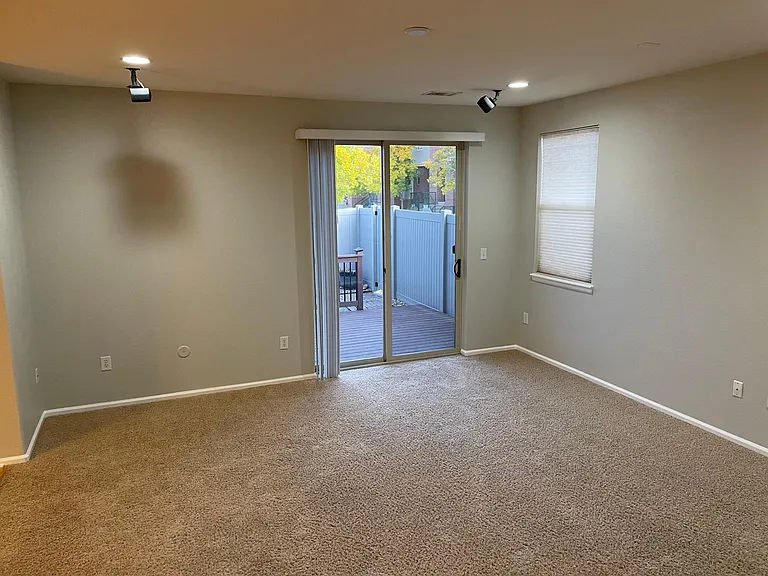 Living room and glass doors to fenced in patio and yard. See 3D Home Tour for 3D Views of Living Room.