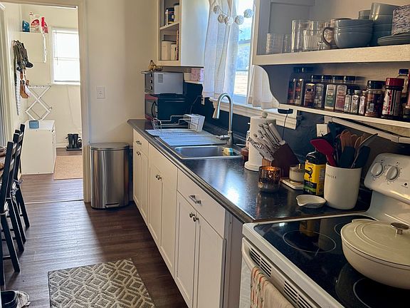 Kitchen with a view into the mudroom and laundry room.