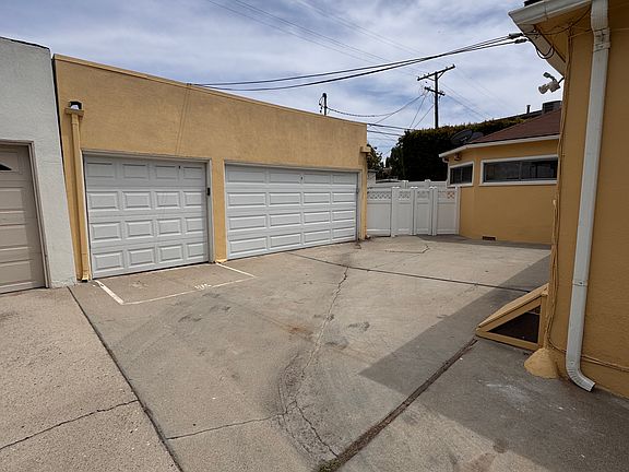 Three-car garage. This building will be converted into an Accessory Dwelling Unit (ADU), and the driveway will then be unavailable for tenant use.