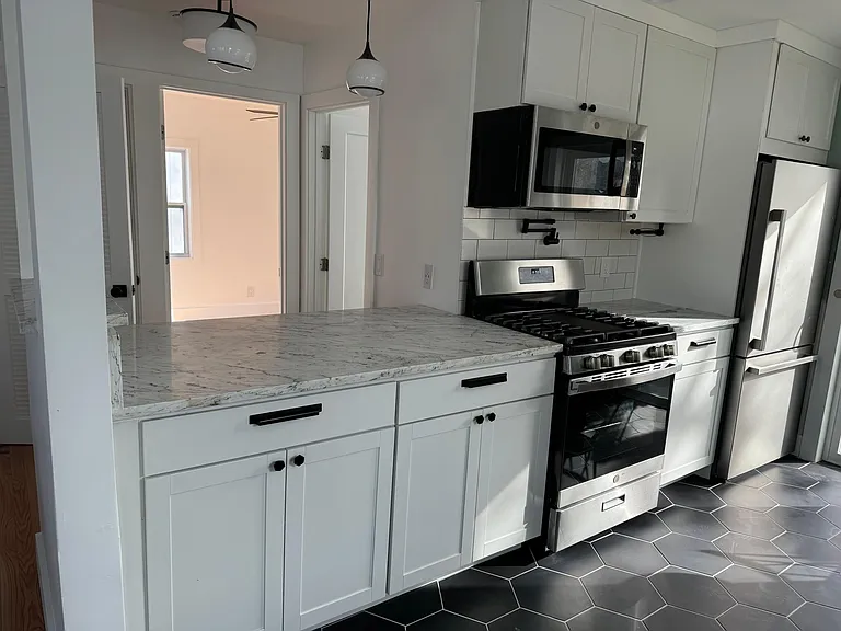 Looking from living room into kitchen at breakfast bar