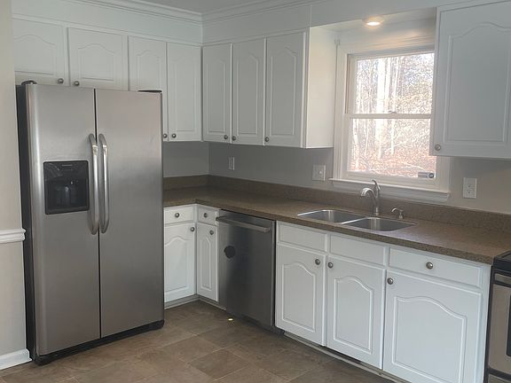 Newly painted wood cabinets. Window over kitchen sink.