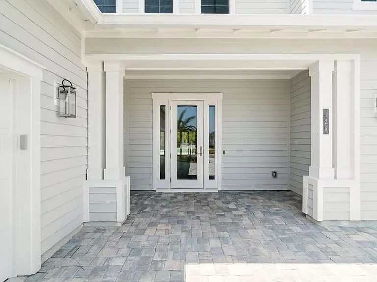 covered front entry with paver driveway