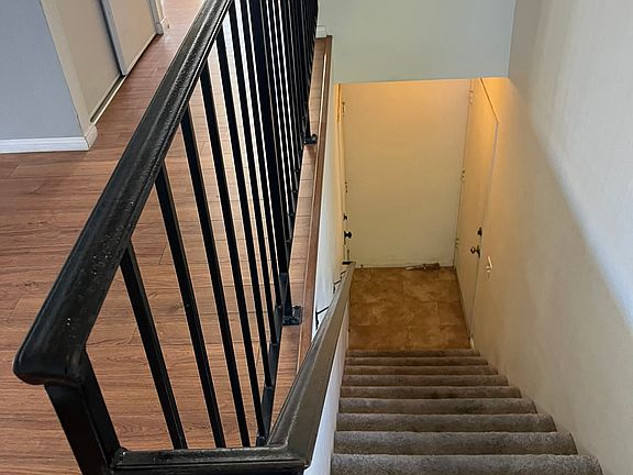 Stairs to upper level. Garage door and entry door at the bottom landing.
