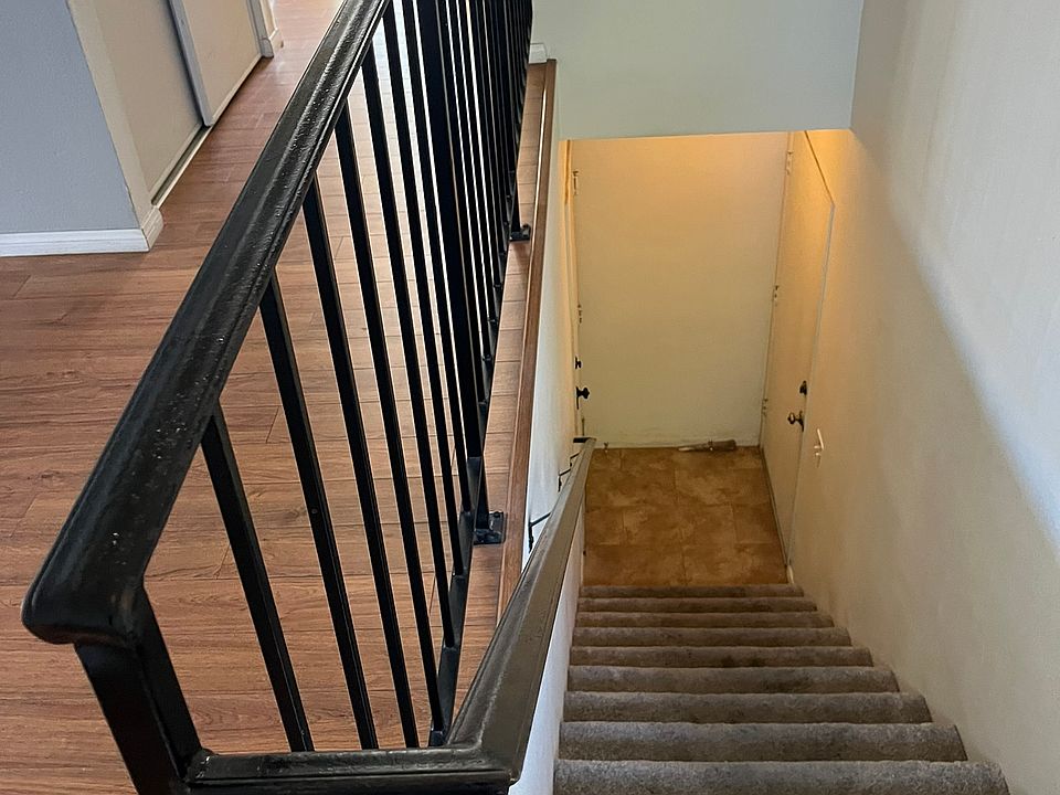 Stairs to upper level. Garage door and entry door at the bottom landing.