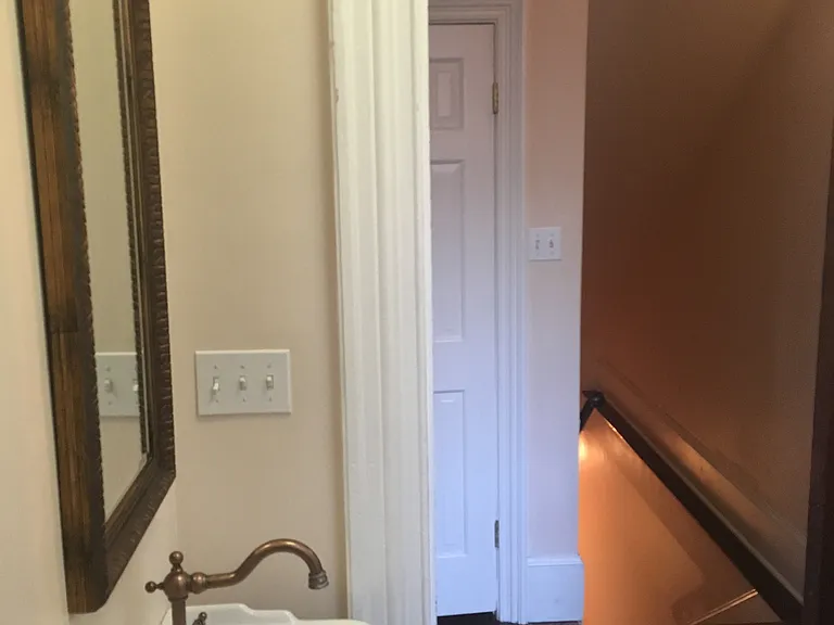 Powder room/half bathroom looking at closet and downstairs
