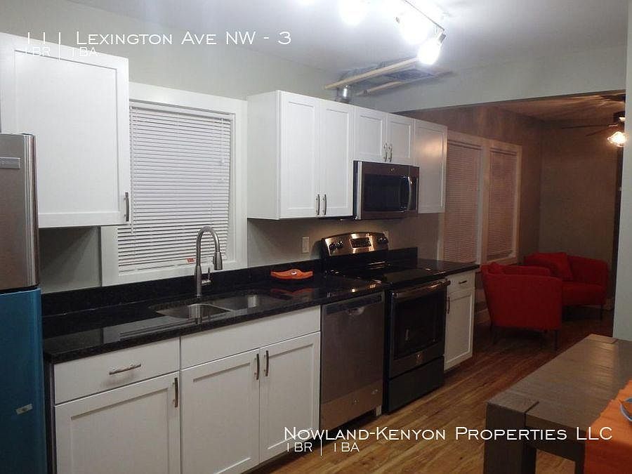 Line kitchen with refrigerator, dishwasher, microwave and stove. Eat in kitchen next to the refrigerator.